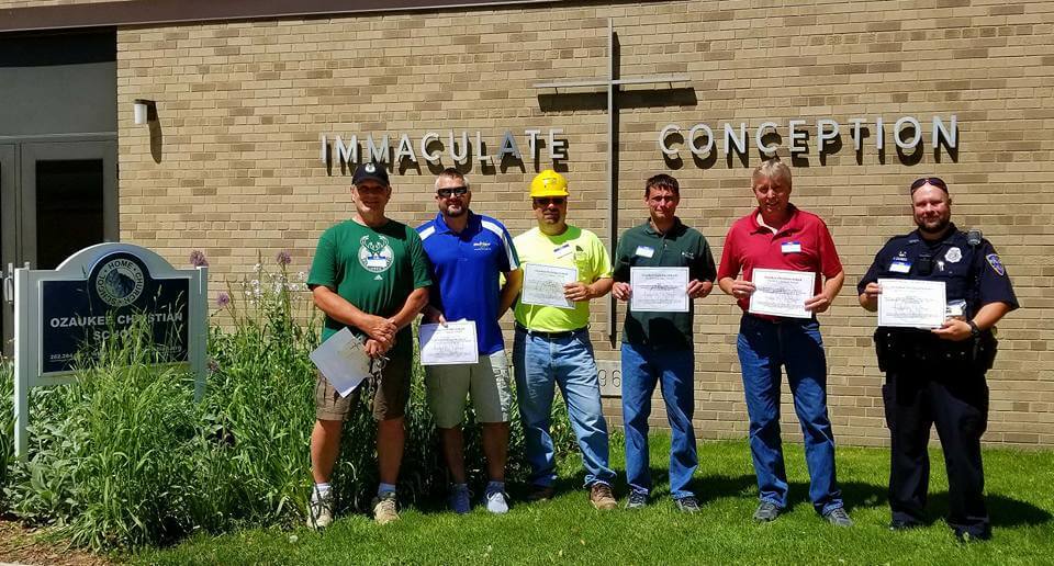 Nick Kertscher (second from left), owner of Magic Touch Carpet Cleaning and Water Damage Restoration receiving the "Character Quality Award" from Ozaukee Christian School after tackling the school's flooding and water damage restoration in 2017.